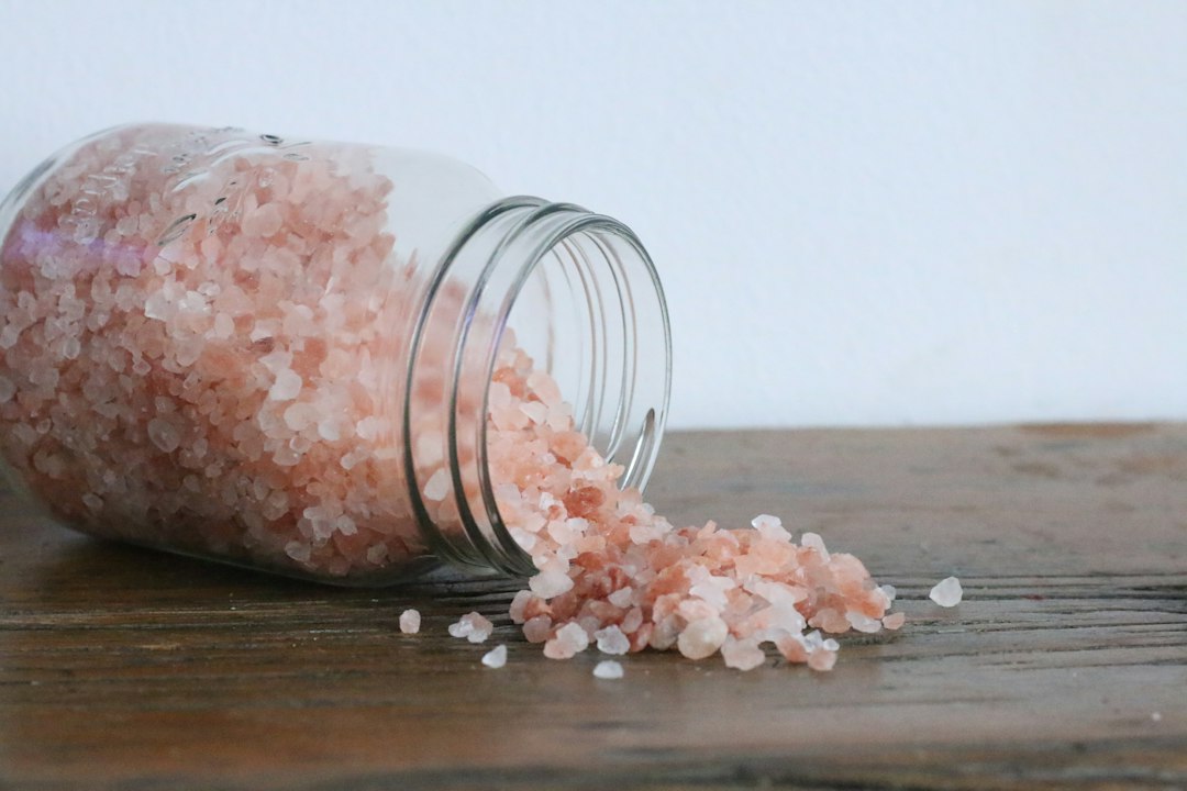 Glass of water with natural pink salt crystals for fasting hydration